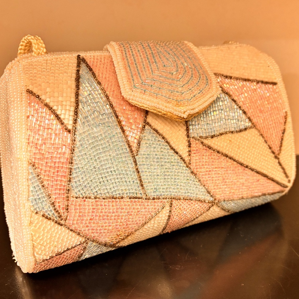 Adorable geometric beaded purse.White strap.Used,good condition.white, blue,pink
